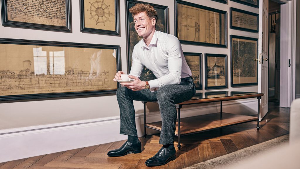 Man in work clothes wearing Dunkeld slip-on brogue black shoes