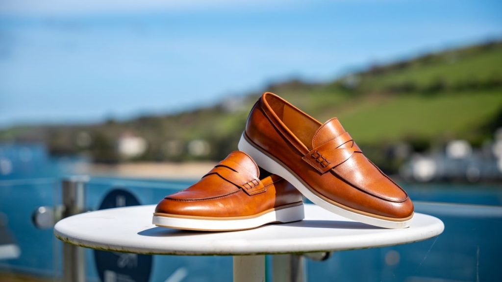 Ibiza loafers perched on occasion table with Salcombe estuary in the background