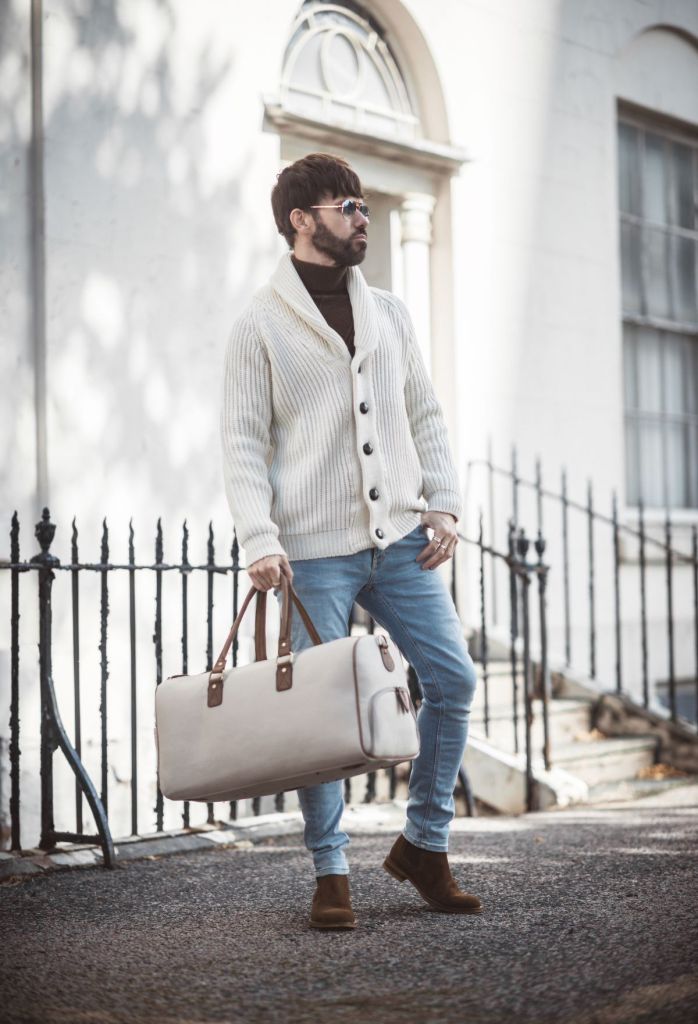 Your Average Guy wearing Herring by Peregrine's men's shawl neck cardigan in cream/ecru with blue jeans and brown boots